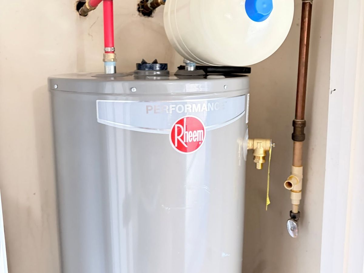 New gas tank water heater in a closet