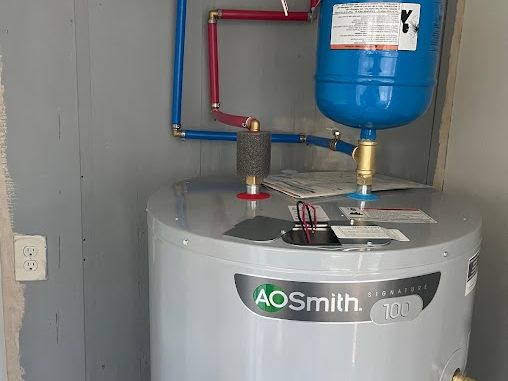 New electric tank water heater with blue and red PEX