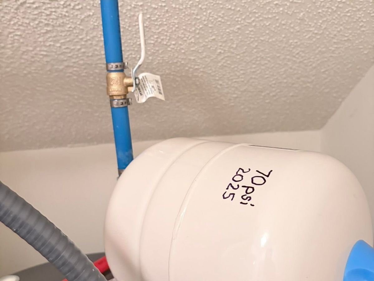 White thermal expansion tank marked 70 PSI