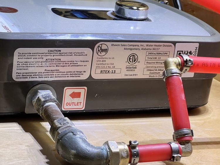 Compact electric water heater on a wall