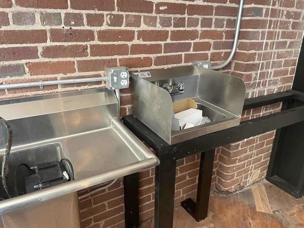 Stainless steel sinks on a black stand
