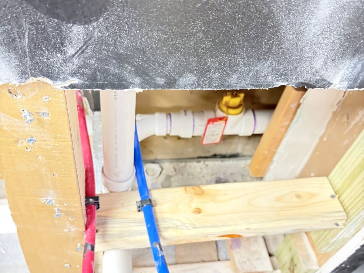 Opened wall with new red and blue PEX stub-outs